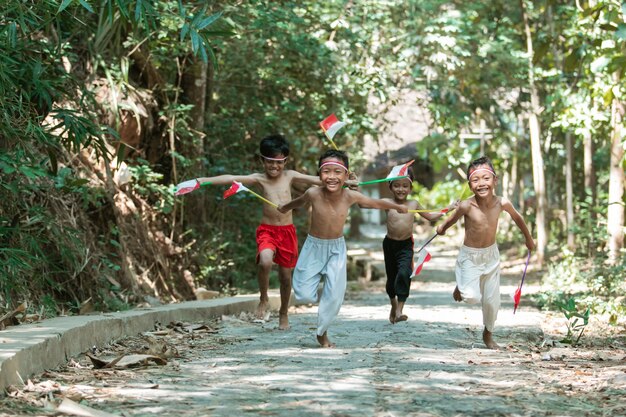 group of kids running without clothes when holding flags