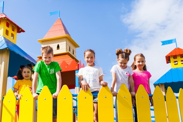 Group of kids standing on a wonderful playground in the form of a castle