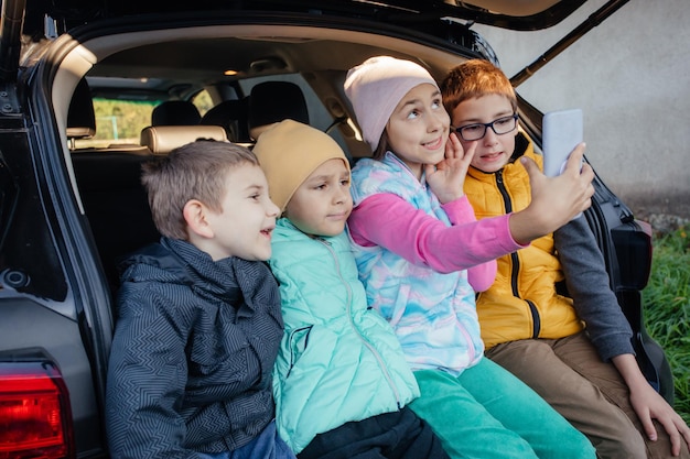 Group of kids taking selfies with smartphone