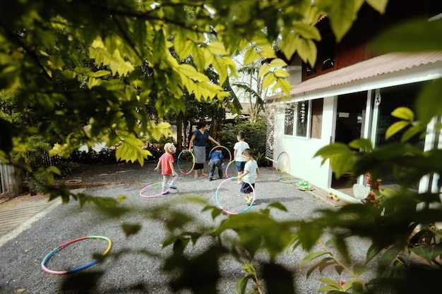 Photo group of little  asian kids playing in garden,home schooler and waldorf education concept.