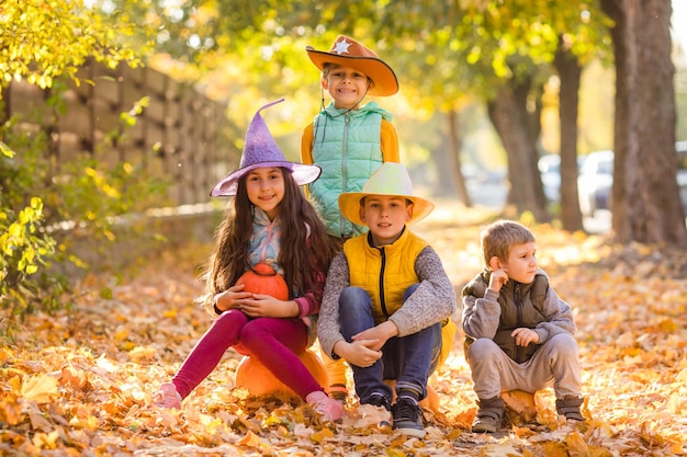 Group of little kids enjoying harvest festival celebration at pumpkin fields