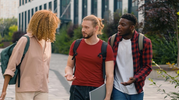 Group of mad emotional students multiracial friends caucasian man guy with african american woman