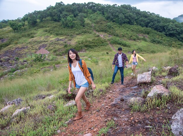 Group of male and female friends walking across a beautiful mountain