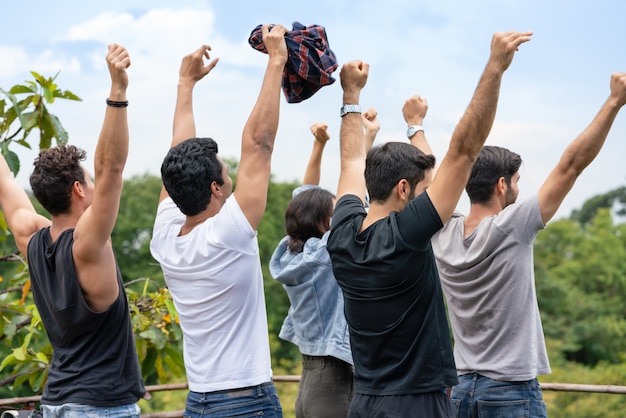 Group of man hands raised together