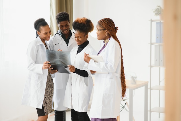 Group of medical doctors in office with patient's x-ray