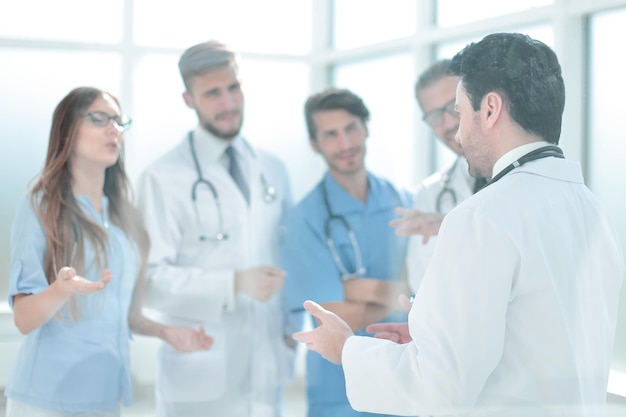 Group of medical staff is discussing in the corridor of the clinic