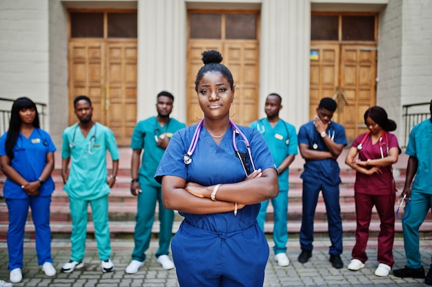 Group of medical students posed outdoor against university door