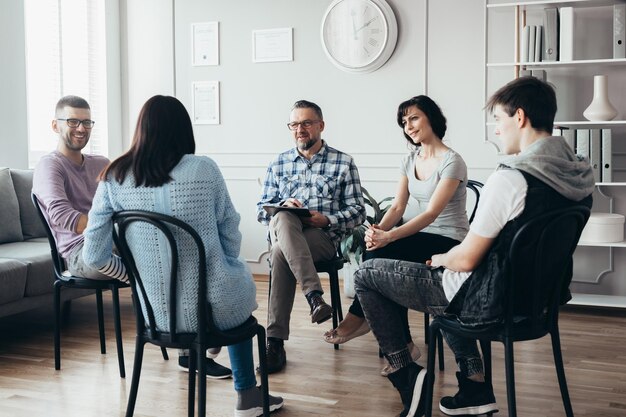 Photo group meeting with counselor for people trying to gain life balance