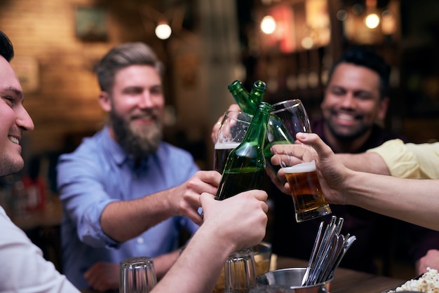 Group of men making a cheers for good weekend