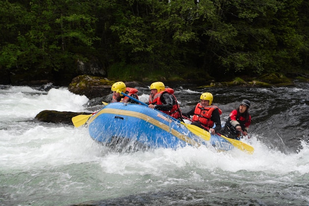 Group of men rafting over the river at Norway