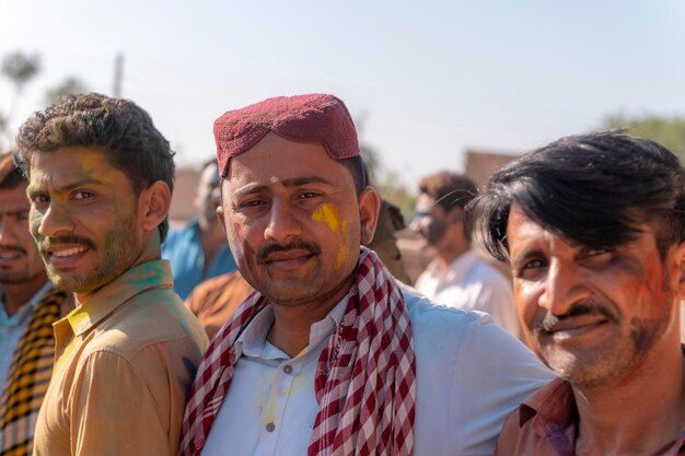 A group of men with their faces painted in bright colors