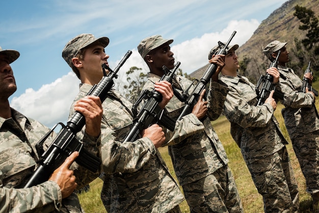 Group of military soldiers standing with rifles