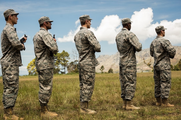 Group of military soldiers standing with rifles