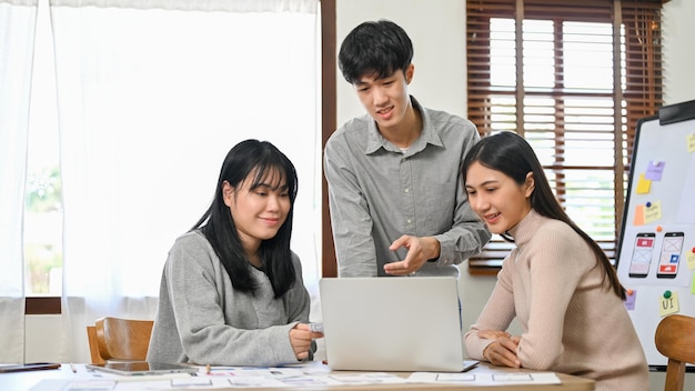 Group of millennial Asian website and mobile application developers startup are in the meeting