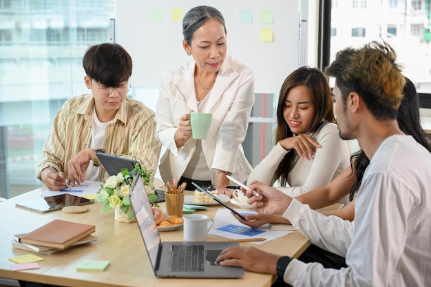 A group of millennial developers having a wonderful meeting with senior manager