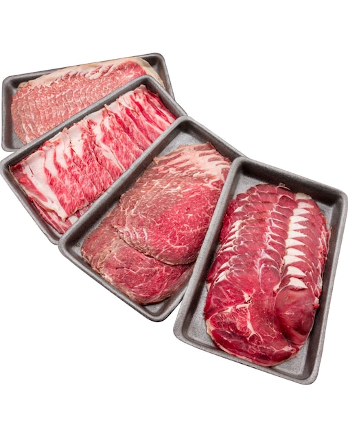 Group of mix raw beef. Sliced raw beef place in a row on a black plastic tray isolated on a white background. Sliced ââmeat for cooking, fresh meat for grilling, yakiniku, sukiyaki or shabu.