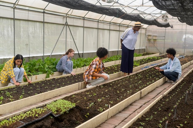 Group of mixed race students and teacher learning agriculture technology in smart farming