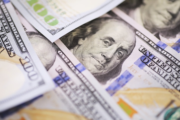 Group of money stack of 100 US dollars banknotes a lot of the background texture. Cash money in a large pile as a finance background.