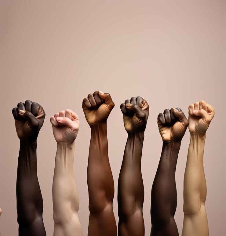 Photo group of multi color fists in front of an empty background