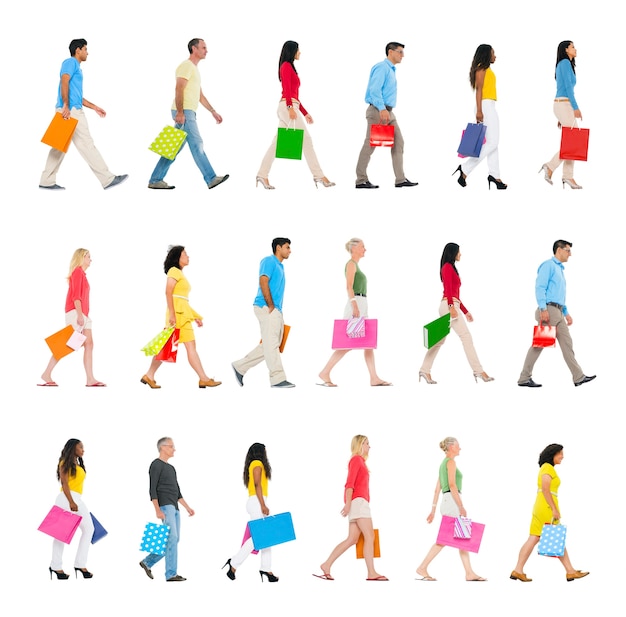 Photo group of multi-ethnic people walking forward with shopping bags.