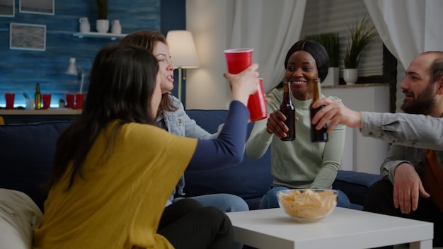 Group of multicultural friends having fun during entertainment wekeend party