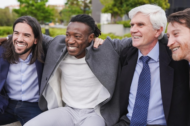 Photo group of multiethnic business men having fun during lunch break outdoor