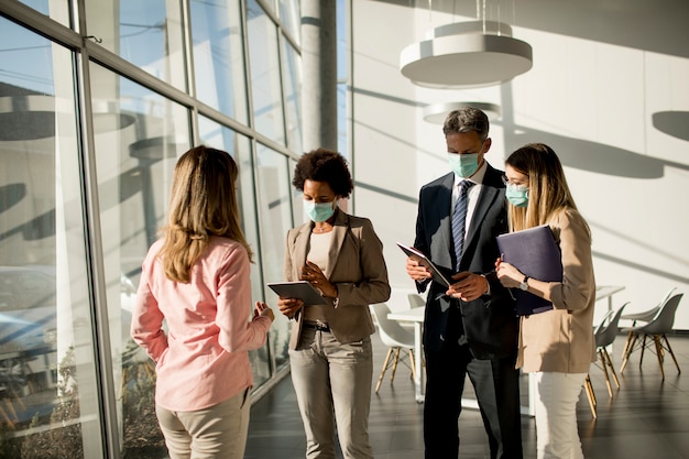 Group of multiethnic business people have a meeting and working in office while wear mask as protection from coronavirus