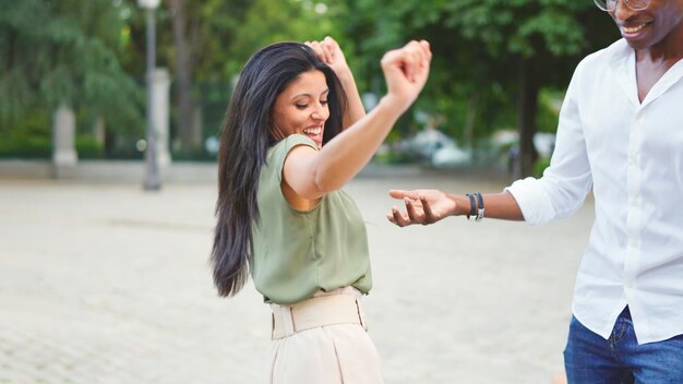 Group of multiethnic friends dancing in the street