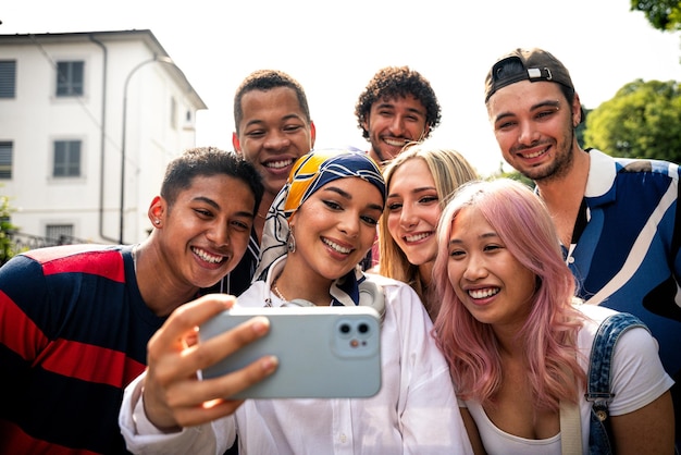 Group of multiethnic teenagers spending time outdoor and having fun