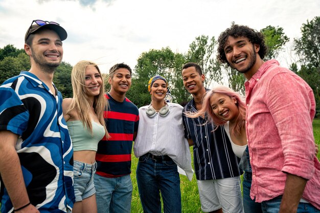 Group of multiethnic teenagers spending time outdoor on a picnic at the park