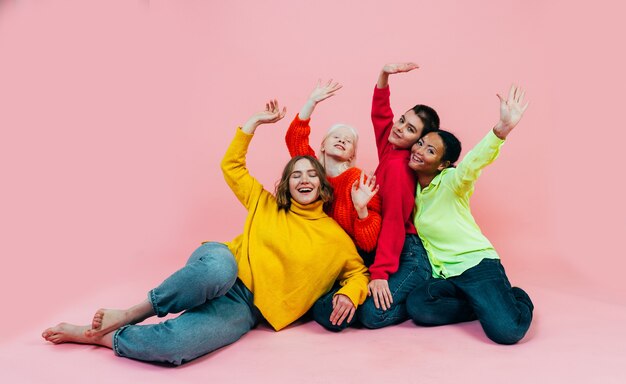 group of multiethnic women with different kind of skin posing together in studio