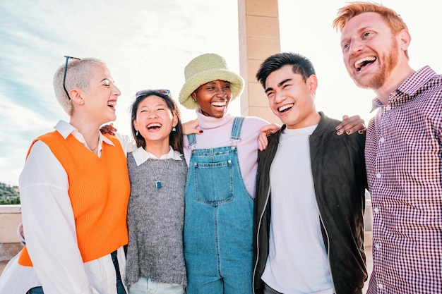 Group of multiracial friends meeting smiling and enjoying in a sunny day