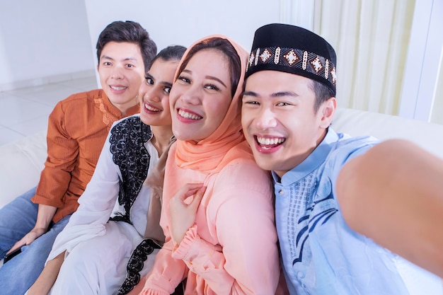 Group of Muslim people taking selfie during Eid