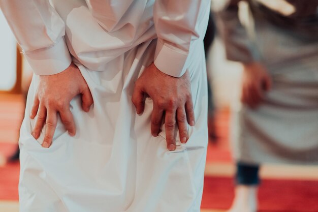 A group of Muslims in a modern mosque praying the Muslim prayer namaz, during the holy month of Ramadan.