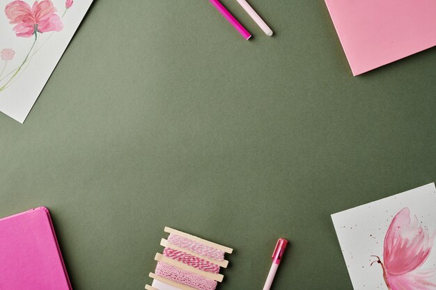 Photo group of notebooks highlighters and drawings with copyspace in the center