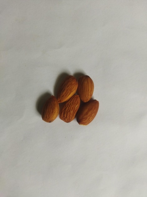 A group of nuts are on a white surface.
