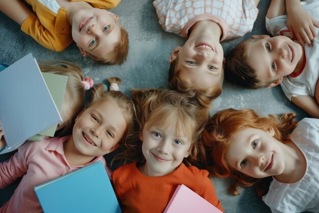 Фото group of seven children are lying on floor with copybooks together