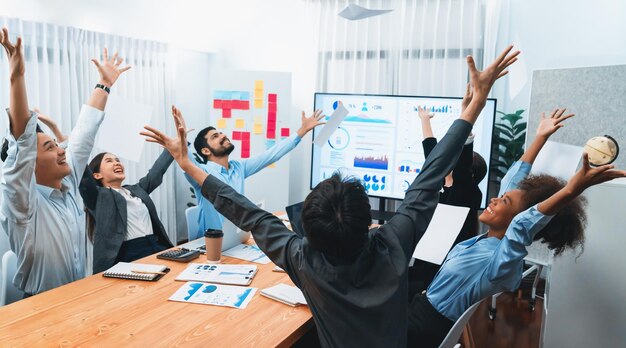 Group of office worker celebrate in meeting room throwing paperwork Concord