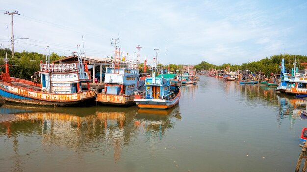 Group of old fishing boats docked in the fishing village of\
thailand phetchaburi