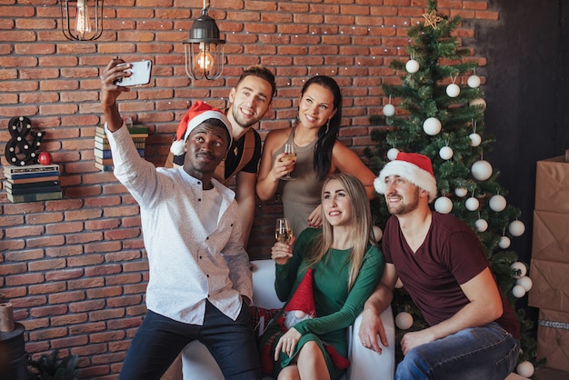 Group of a old friends communicate with each other and make a christmasselfie photo. 