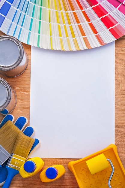 Photo group of paint tools and pantone color palette guide on sheet of paper construction concept