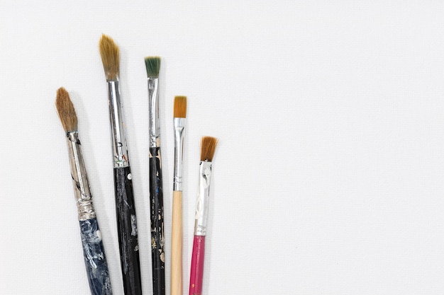 Photo group of paintbrushes on white canvas background. copy space