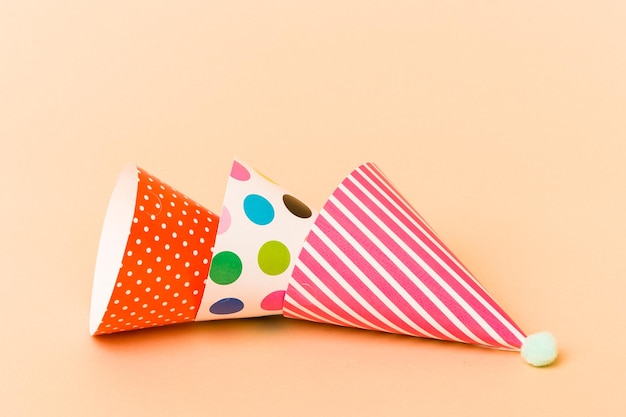 Group of party hats isolated on beige background