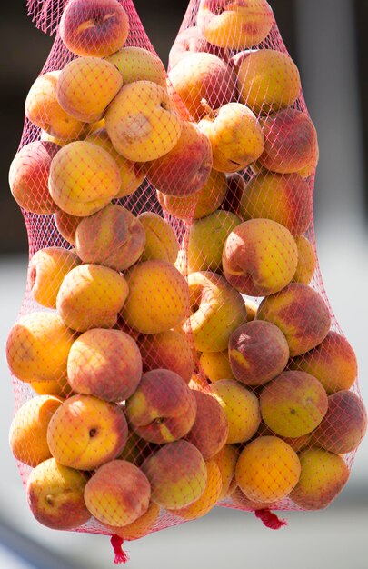 Group of Peaches in bags on sale hanging in a retail shop