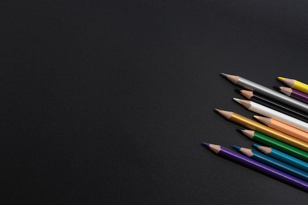 Group of pencils on the black background with copy space