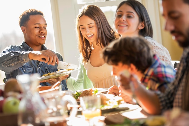 A group of people adults and children seated around a table for a meal