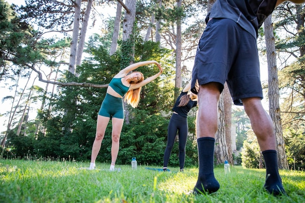 A group of people are exercising in a park together during a fitness class