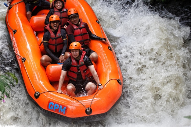 a group of people are riding a raft that says g - g on it.