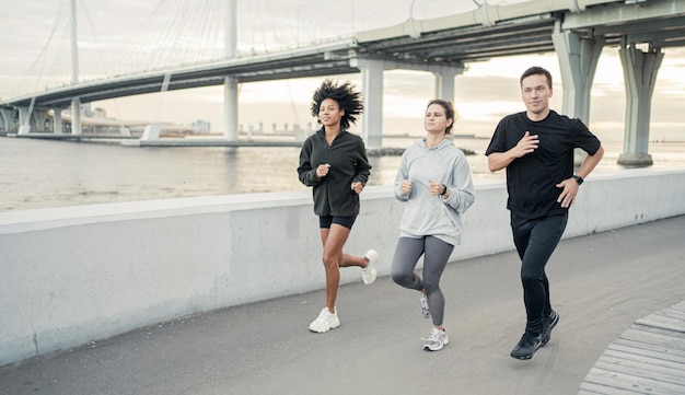 A group of people are runners in sportswear friends workout
fitness running in the city