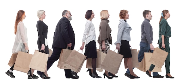 A group of people are running paper shopping bags